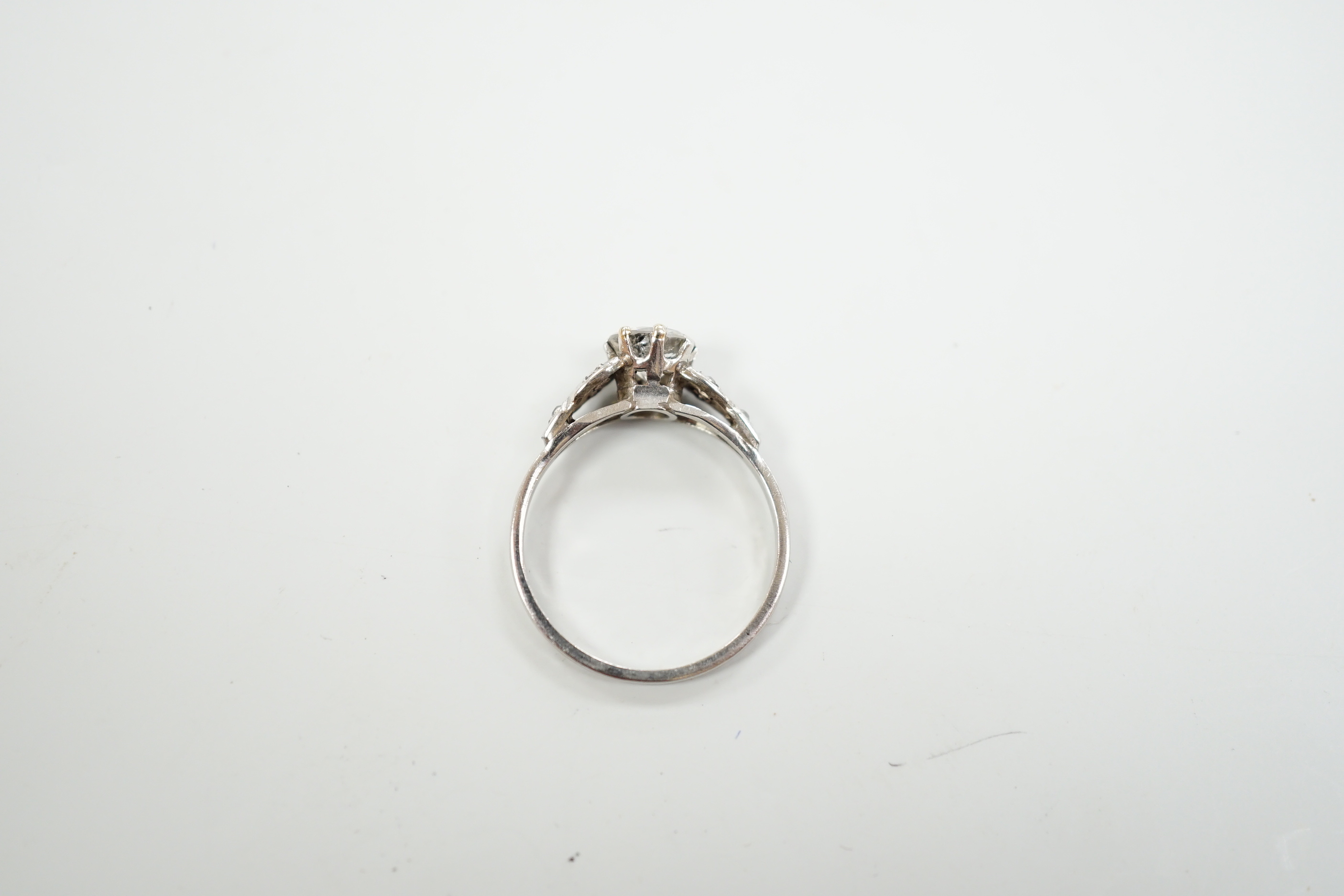 A white metal, stamped plat and single stone diamond ring, with diamond set shoulders, size O, gross weight 3.2 grams